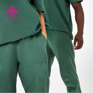 Vlastné logo skladané teplákové nohavice voľného strihu bavlnené unisex joggery s bočnými vreckami