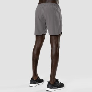 Roba esportiva a l'engròs personalitzada d'assecat ràpid per a home amb cordó de cintura elàstic dins de pantalons curts de niló per a córrer