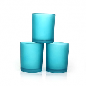 Colorful glass soy candle jars with metal and wooden bamboo lids