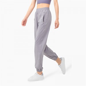 Nye treningsbukser med høy midje og lommer med glidelås Ferskenhofter for kvinner Løstsittende uformelle bukser
