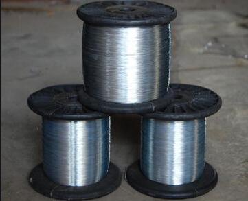 How is galvanized iron wire drawn for production