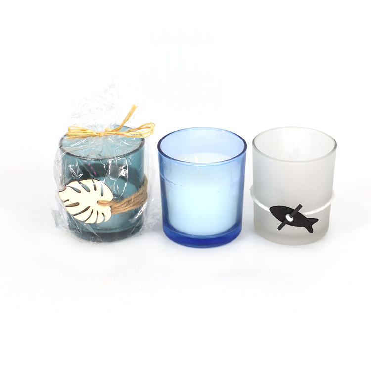 Glass cup candle decorated with straw rope