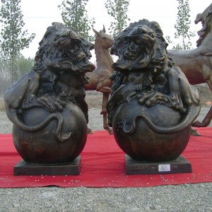 Bronze wild lion sculpture with ball