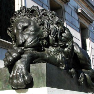 Bronze wild lion sculpture with ball