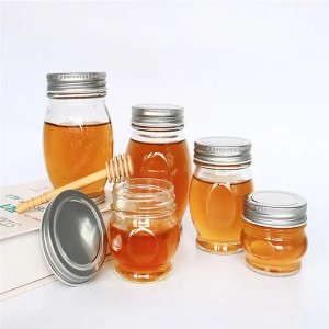 Vasetti di miele in vetru trasparente cù u coperchiu in metallo