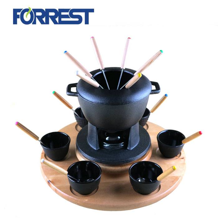 Black cast iron fondue set with base cup and forks
