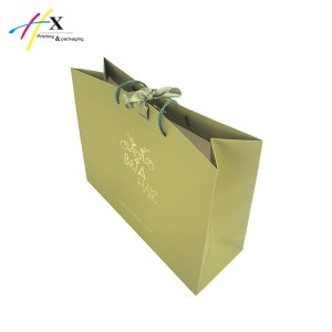 Green paper bag with gold logo for hair
