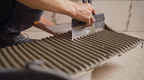 What effects does redispersible polymer powder have on tile adhesive?