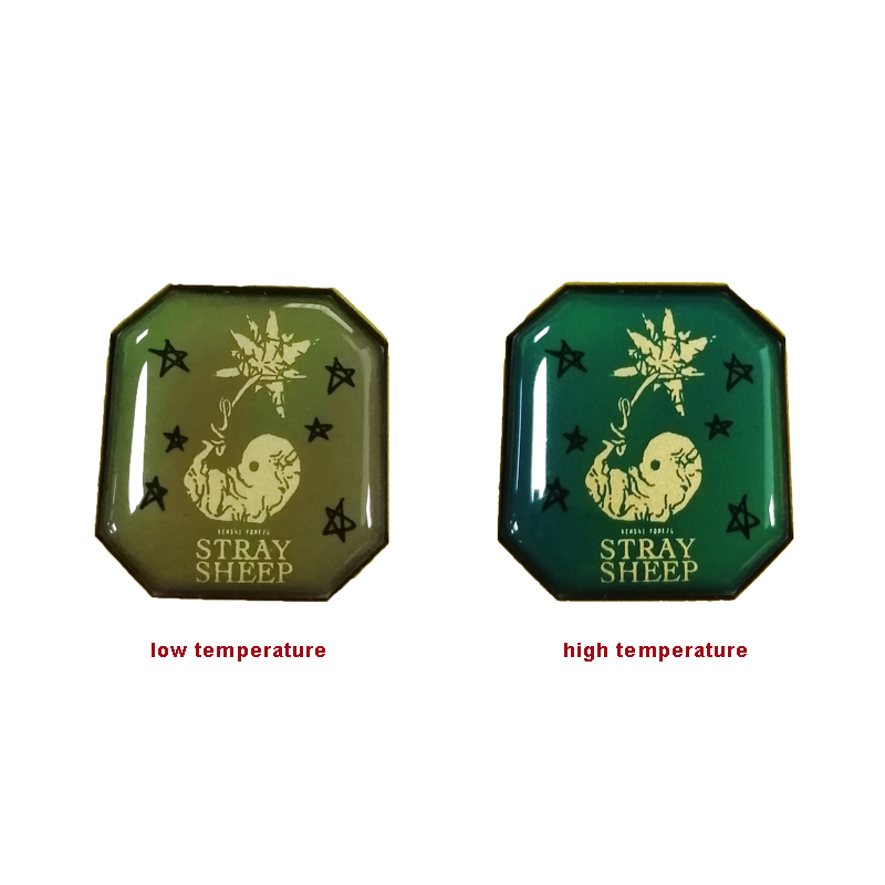 Thermal sensing color-changing metal badge