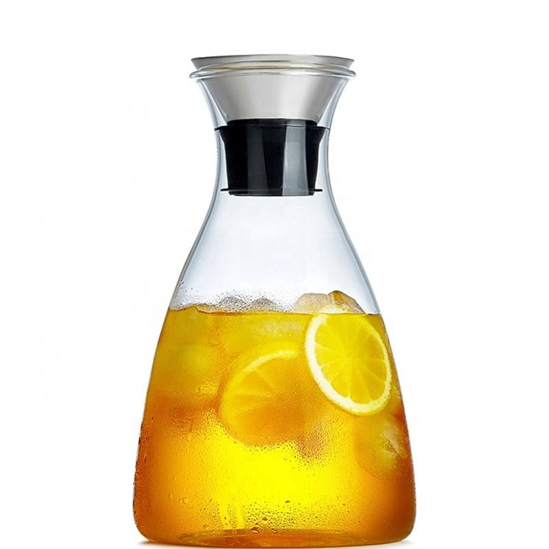 Iced tea in the pitcher and the glass. Jug of cold iced drink with