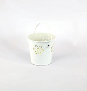 Citronella candle in iron bucket with flower pattern and handle