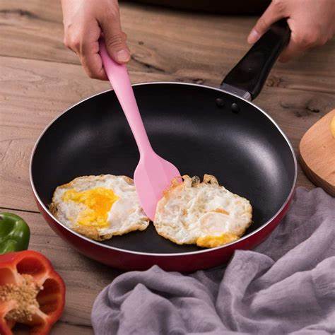 What is the reason for the stickiness of silicone kitchen utensils after use?