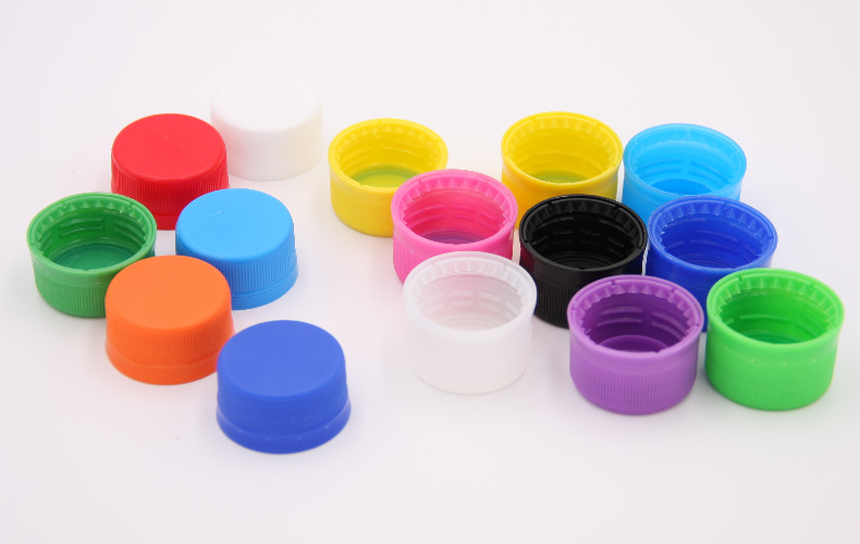 What are the processes for producing plastic bottle caps?