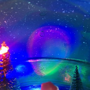 Plastic LED light up noel seasonal ornament, tabletop decor animated musical Xmas scene Green Santa Snowball