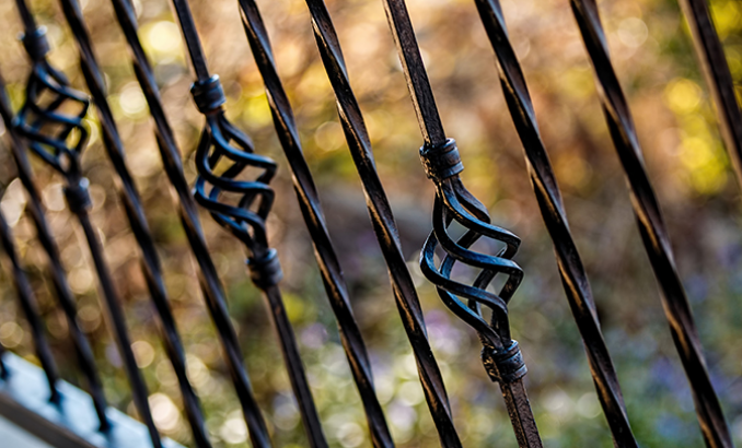 How should wrought iron railings be maintained?