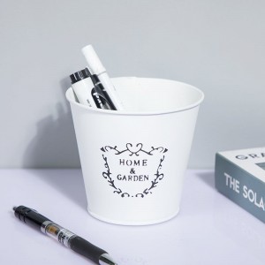 Small round metal bucket with the words “HOME & GARDEN” on the front,white color